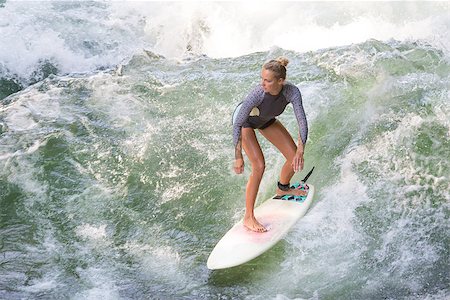 Atractive sporty girl in neoprene shorty surfing on famous artificial river wave in Englischer garten, Munich, Germany. Stock Photo - Budget Royalty-Free & Subscription, Code: 400-09064335