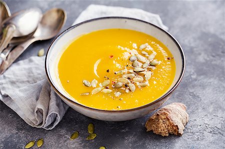 simsearch:400-05709481,k - Bowl of squash soup with basil leaf and pumpkin seeds. Stock Photo - Budget Royalty-Free & Subscription, Code: 400-09065413