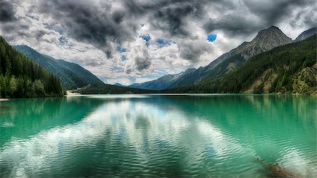 simsearch:400-09237738,k - Lake of Anterselva surrounded by mountains with blue sky and dark clouds in the background on a summer day, Sud Tirol, Italy Foto de stock - Royalty-Free Super Valor e Assinatura, Número: 400-09065638