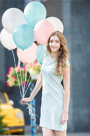 young beautiful woman with flying multicolored balloons in the city Stock Photo - Budget Royalty-Free & Subscription, Code: 400-09066471