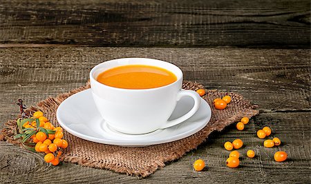 Tea of sea-buckthorn berries on wooden table with blurred background Stock Photo - Budget Royalty-Free & Subscription, Code: 400-09067685