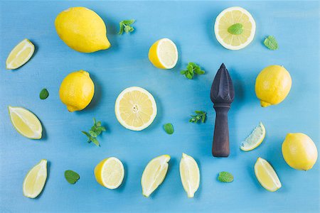 Fresh lemon citrus fruits with citrus reamer on blue bakground Stock Photo - Budget Royalty-Free & Subscription, Code: 400-09062742