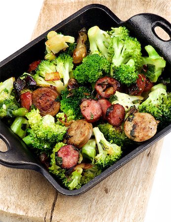 stew sausage - Homemade Stew with Broccoli and Grilled Sausages in Black Iron Cast on Wooden Board isolated on White background Stock Photo - Budget Royalty-Free & Subscription, Code: 400-09062867