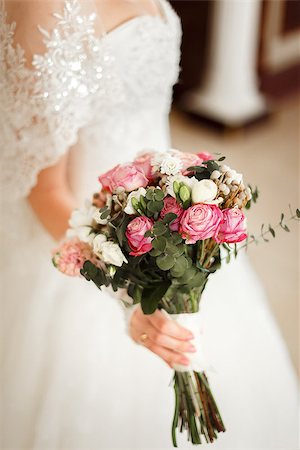 simsearch:400-04762831,k - Young bride in white dress holding a wedding bouquet. The bouquet is decorated in a modern style with pink and white flowers with decorative greenery. Stock Photo - Budget Royalty-Free & Subscription, Code: 400-09063080
