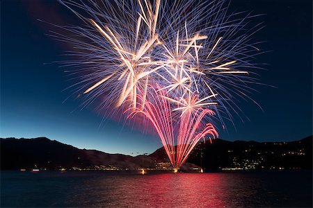 parties boats - Fireworks on the lakefront of Luino over the Major Lake in a summer evening with blue sky and mountains in the background Stock Photo - Budget Royalty-Free & Subscription, Code: 400-09063160