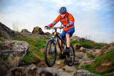 simsearch:400-09084281,k - Cyclist Riding the Mountain Bike on the Beautiful Spring Rocky Trail. Extreme Sport Concept Fotografie stock - Microstock e Abbonamento, Codice: 400-09063274