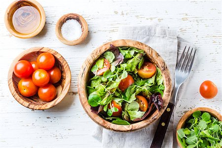 salad top view isolated - Vegetarian salad with lettuce and tomatoes in olive wooden bowl on wihte background Stock Photo - Budget Royalty-Free & Subscription, Code: 400-09063565