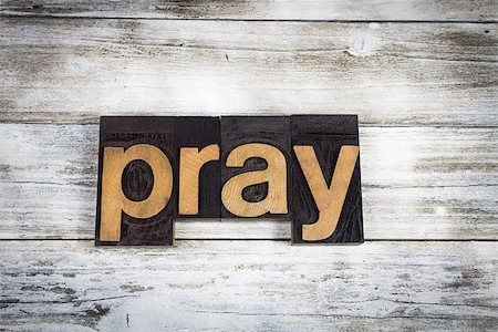 The word "pray" written in wooden letterpress type on a white washed old wooden boards background. Photographie de stock - Aubaine LD & Abonnement, Code: 400-09063584