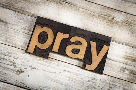 The word "pray" written in wooden letterpress type on a white washed old wooden boards background. Photographie de stock - Aubaine LD & Abonnement, Code: 400-09063585