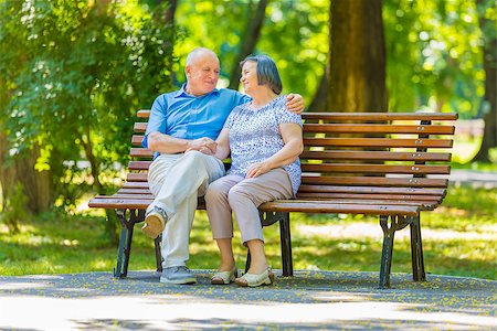 Senior couple talking while sitting on bench in summer park. Stock Photo - Budget Royalty-Free & Subscription, Code: 400-09063776