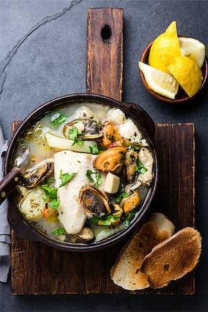 Seafood fish soup in clay bowls served with lemon and coriander. Top view, copy space. Stock Photo - Budget Royalty-Free & Subscription, Code: 400-09063933