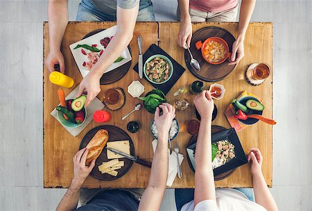 simsearch:400-09011310,k - Top view, Group of people sitting at the wooden table having meal Fotografie stock - Microstock e Abbonamento, Codice: 400-09079862