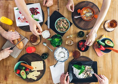 simsearch:400-09011310,k - Top view, Group of people sitting at the wooden table having meal Fotografie stock - Microstock e Abbonamento, Codice: 400-09079863