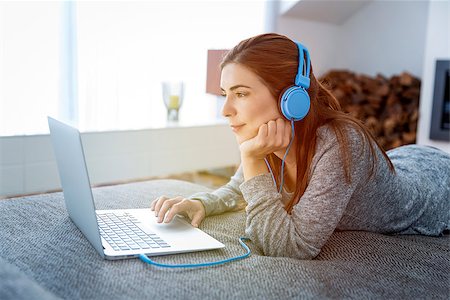 fireplace computer - Beautiful woman working at home with a laptop while listen music Stock Photo - Budget Royalty-Free & Subscription, Code: 400-09079933