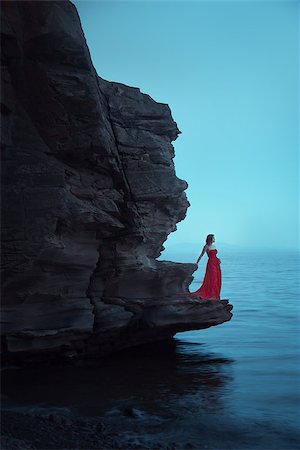 evening dress on beach - A sad woman in red dress near the sea in evening. Long time exposure Stock Photo - Budget Royalty-Free & Subscription, Code: 400-09070184