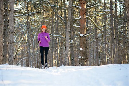 simsearch:400-07509642,k - Young Woman Running in the Beautiful Winter Forest at Sunny Frosty Day. Active Lifestyle Concept. Stock Photo - Budget Royalty-Free & Subscription, Code: 400-09084282