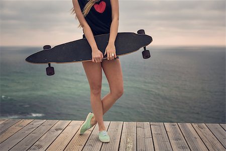 Beautiful and fashion young woman posing with a skateboard Stock Photo - Budget Royalty-Free & Subscription, Code: 400-09084363