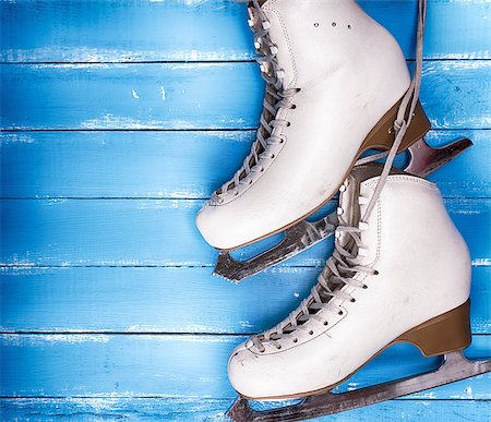 a pair of worn white leather skates for figure skating on a blue wooden background, empty space on the left Stock Photo - Budget Royalty-Free & Subscription, Code: 400-09084908