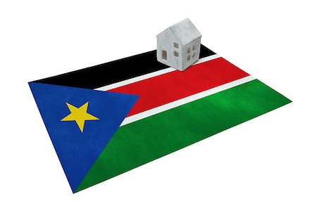 profugo (uomo e donna) - Small house on a flag - Living or migrating to South Sudan Fotografie stock - Microstock e Abbonamento, Codice: 400-09084952