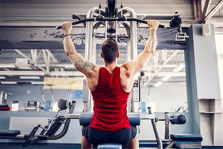 simsearch:400-05180877,k - Strong Bearded Bodybuilder Doing Heavy Weight Exercise For Back On Machine. Stock Photo - Budget Royalty-Free & Subscription, Code: 400-09080291