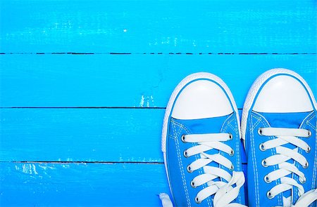 simsearch:400-05283349,k - sport textile blue sneakers with white laces on a blue wood background of parallel boards, empty space at the top Stock Photo - Budget Royalty-Free & Subscription, Code: 400-09081108