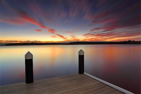 simsearch:400-07514503,k - Relaxing at Kikatinalong Jetty long exposure after a vivid sunset Stock Photo - Budget Royalty-Free & Subscription, Code: 400-09081197