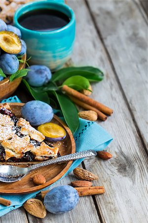 Homemade traditional plum pie with cinamon and almonds with coffee on old wooden background Stock Photo - Budget Royalty-Free & Subscription, Code: 400-09081294