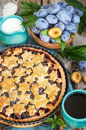 Homemade traditional plum pie with cinamon and almonds with coffee on old wooden background Stock Photo - Budget Royalty-Free & Subscription, Code: 400-09081290