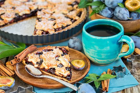 Homemade traditional plum pie with cinamon and almonds with coffee on old wooden background Stock Photo - Budget Royalty-Free & Subscription, Code: 400-09081291