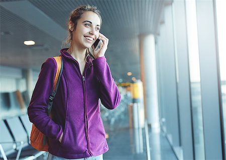 Girl at the airport window talking by phone Stock Photo - Budget Royalty-Free & Subscription, Code: 400-09081381