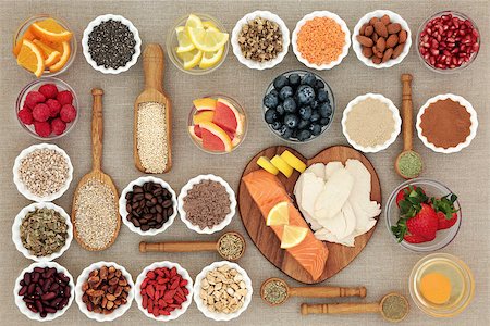 Super food for healthy dieting concept with high protein fish and meat, fruit, pulses, nuts, cereals and grains including herbs used as appetite suppressants. Foods high in omega 3, anthocyanins, antioxidants, fiber and vitamins. Stock Photo - Budget Royalty-Free & Subscription, Code: 400-09081596