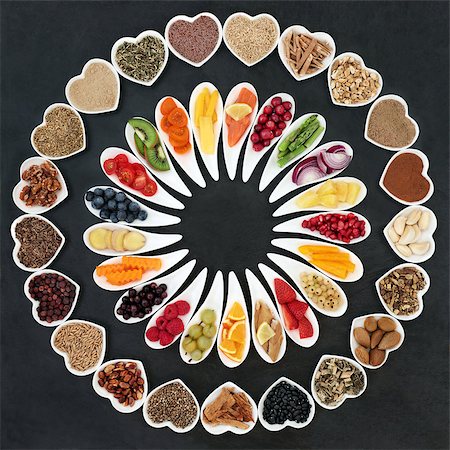 Health food wheel for a healthy heart concept with vegetables, fruit, fish, nuts, seeds, supplement powders, cereal and herbs for herbal medicine. High in omega 3 fatty acid, anthocyanins, fiber, antioxidants and vitamins. Stock Photo - Budget Royalty-Free & Subscription, Code: 400-09081604