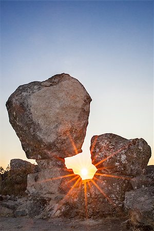 Sun rising between megalithic monument of Cancho Que Se Menea. In English shifting rock. Montanchez, Spain Stock Photo - Budget Royalty-Free & Subscription, Code: 400-09082113