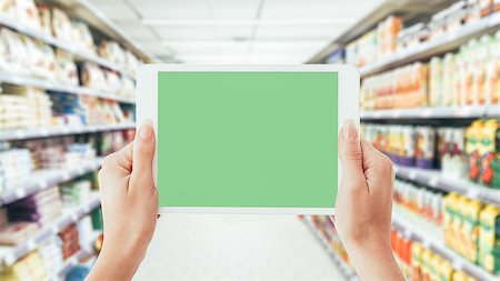 simsearch:400-09095525,k - Woman using a digital tablet in the supermarket aisle: shopping, technology and augmented reality concept Photographie de stock - Aubaine LD & Abonnement, Code: 400-09082187