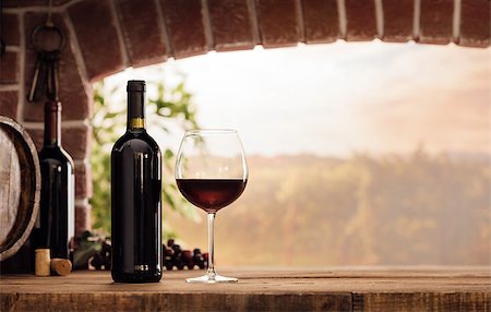 Red wine tasting in the wine cellar: wineglass and bottles next to the window and panoramic view of vineyards at sunset Stock Photo - Budget Royalty-Free & Subscription, Code: 400-09082232
