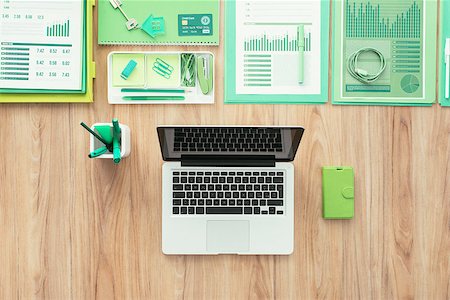 simsearch:400-08613671,k - Laptop, green office supplies and financial reports on a wooden desktop, green business and ecology concept Stock Photo - Budget Royalty-Free & Subscription, Code: 400-09082263