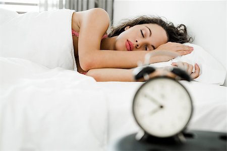 simsearch:400-08299475,k - Beautiful young woman waking up with the alarm clock Stock Photo - Budget Royalty-Free & Subscription, Code: 400-09082360