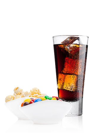 popcorn pattern - Round colorful coated sweet candies and popcorn in white bowl with cola soda drink on white background Stock Photo - Budget Royalty-Free & Subscription, Code: 400-09082856