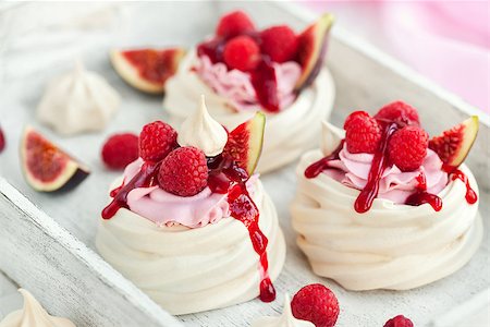 pavlova - Delicious mini Pavlova meringue cake decorated with fresh raspberry, figs  and berry sauce on white background Stock Photo - Budget Royalty-Free & Subscription, Code: 400-09083179