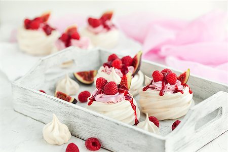 Delicious mini Pavlova meringue cake decorated with fresh raspberry, figs  and berry sauce on white background Stock Photo - Budget Royalty-Free & Subscription, Code: 400-09083180
