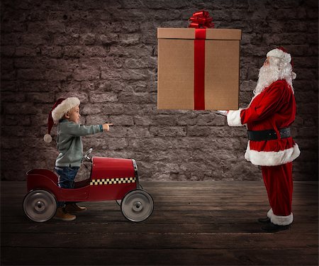 Amazed child watch Santa Claus who gives him the CHristmas gift Stock Photo - Budget Royalty-Free & Subscription, Code: 400-09083468