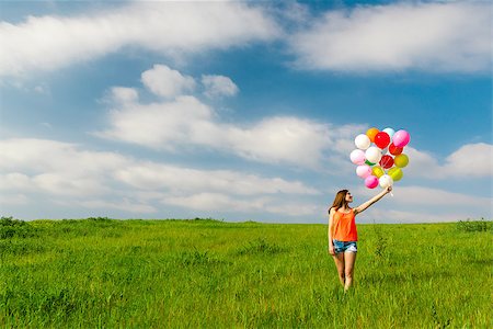 simsearch:400-06077546,k - Young beautiful woman having fun with balloons on a green meadow Stockbilder - Microstock & Abonnement, Bildnummer: 400-09083638