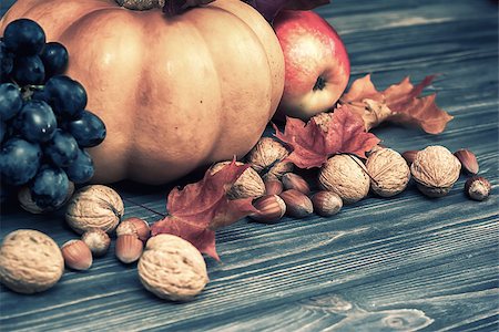 Pumpkin, apple, nuts, berries with maple leaves on wooden background. Autumn card thanksgiving. Halloween. Vintage toned Photographie de stock - Aubaine LD & Abonnement, Code: 400-09083753
