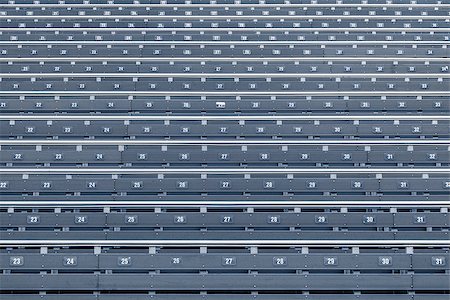 simsearch:400-06087440,k - Blue seats on the tribune of the stadium. Foto de stock - Royalty-Free Super Valor e Assinatura, Número: 400-09095316