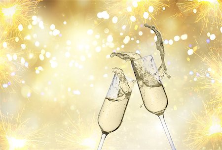 Two festive champagne glasses on golden bokeh background with lights and fireworks Stock Photo - Budget Royalty-Free & Subscription, Code: 400-09095609