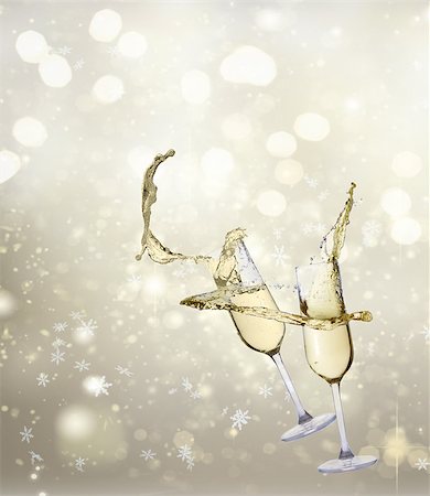 Two festive flying champagne glasses on golden bokeh background with lights Stock Photo - Budget Royalty-Free & Subscription, Code: 400-09095610