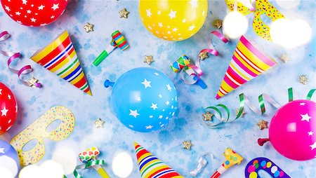 simsearch:400-08012338,k - Bright colorful carnival or party pattern of balloons, streamers and confetti on blue table. Flat lay style, birthday or party greeting card and bokeh lights Foto de stock - Super Valor sin royalties y Suscripción, Código: 400-09096734