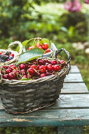 Fresh forest fruit on wood. Fresh organic fruit. Red cherries, blueberries and blackberries Stock Photo - Budget Royalty-Free & Subscription, Code: 400-09096911