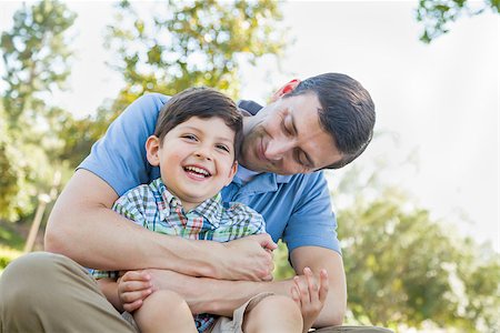 dad son playing wrestling - Loving Young Father Tickling Son in the Park. Stock Photo - Budget Royalty-Free & Subscription, Code: 400-09096934