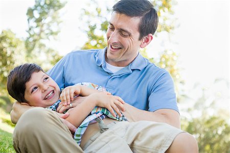 dad son playing wrestling - Loving Young Father Tickling Son in the Park. Stock Photo - Budget Royalty-Free & Subscription, Code: 400-09096935